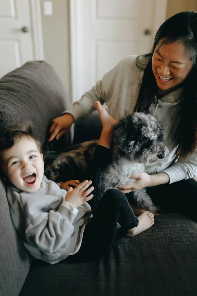 Happy mom, child, and dog living a pest-free life in their home