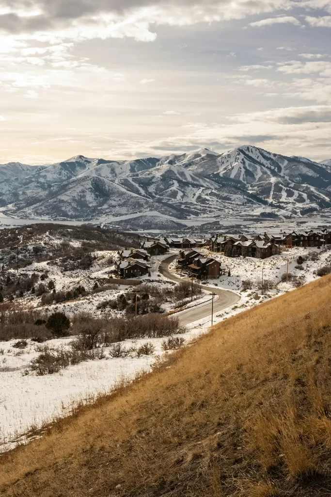 Scenic view of a snow-covered mountain landscape in Utah with rustic houses below