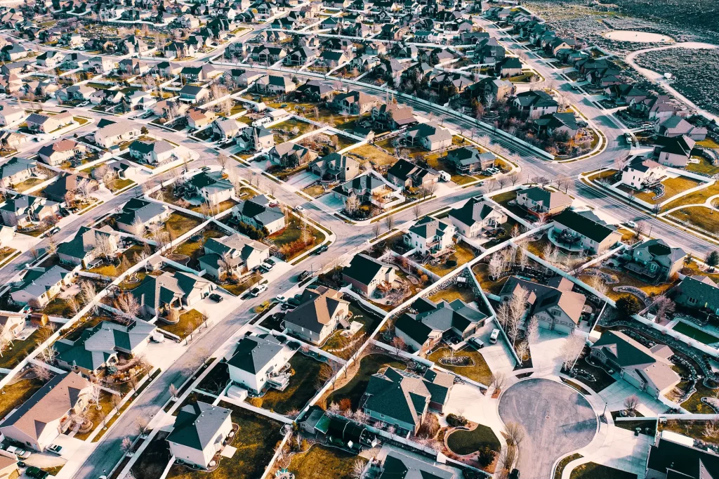 High-angle aerial shot of a suburban neighborhood in Sandy, Utah showcasing residential architecture and streets